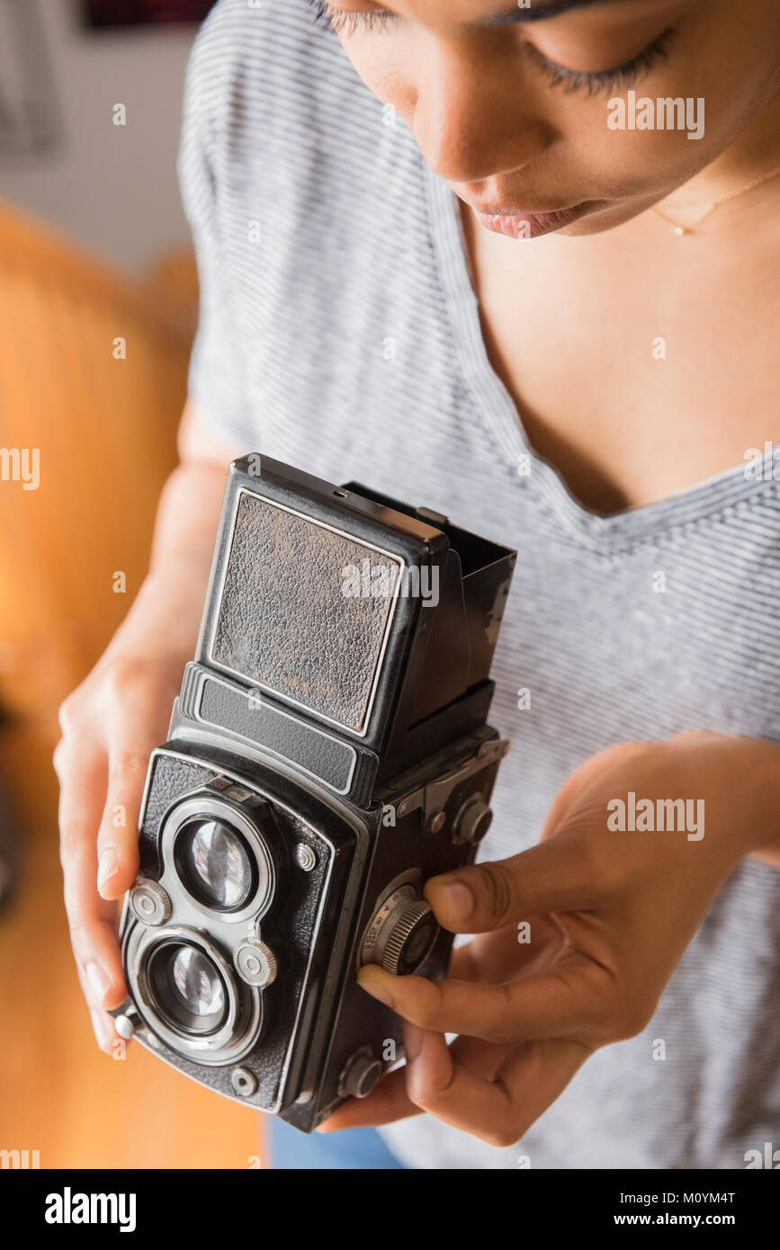 African American woman using old-fashioned camera Stock Photo