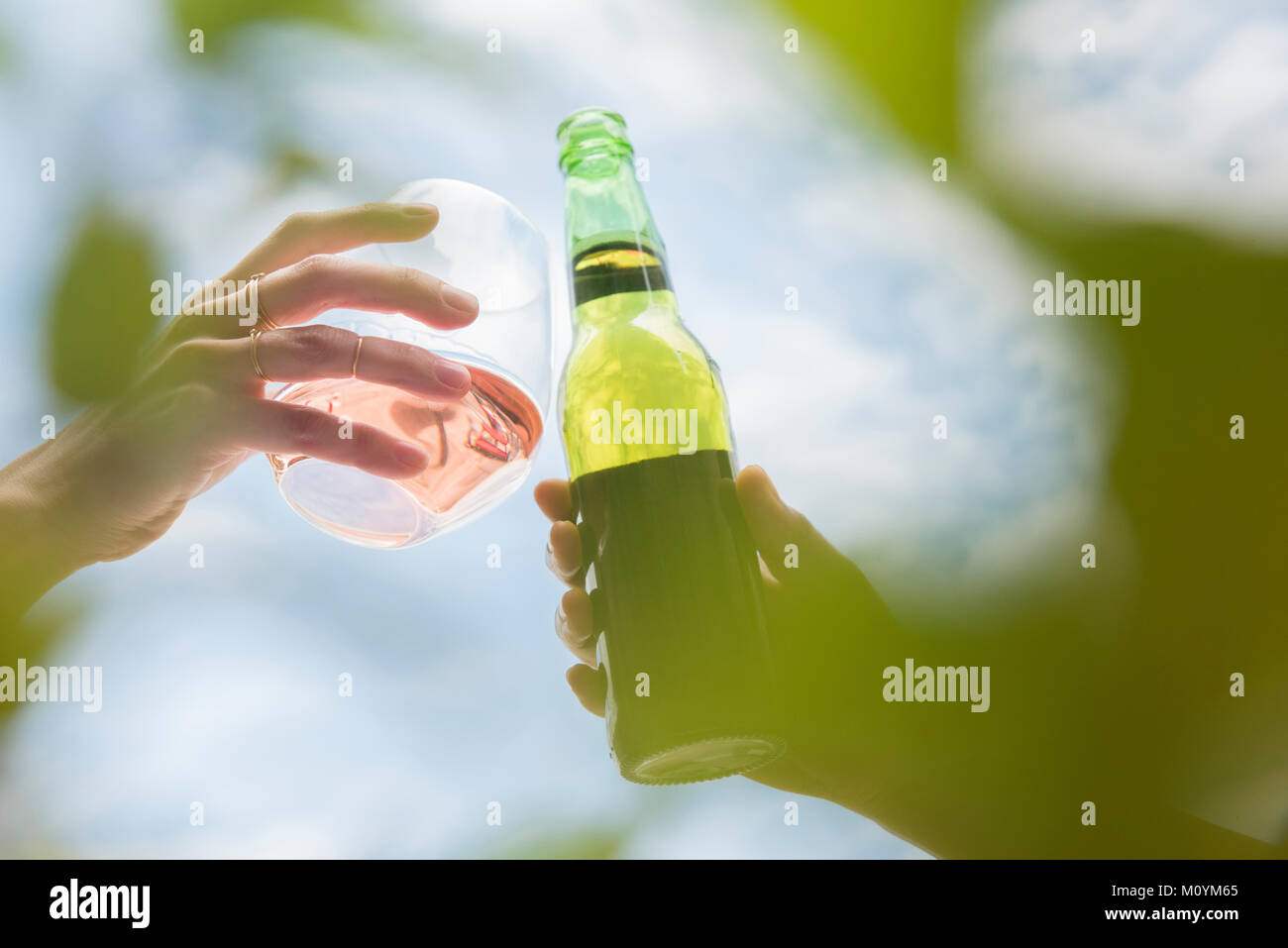 Women toasting with beer and wine Stock Photo