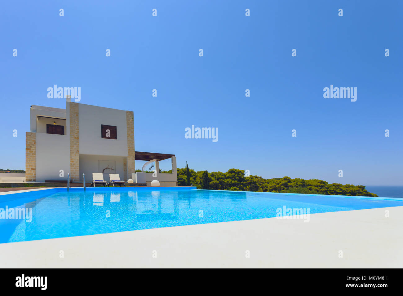 big pool and modern luxury villa with blue sky and trees Stock Photo ...