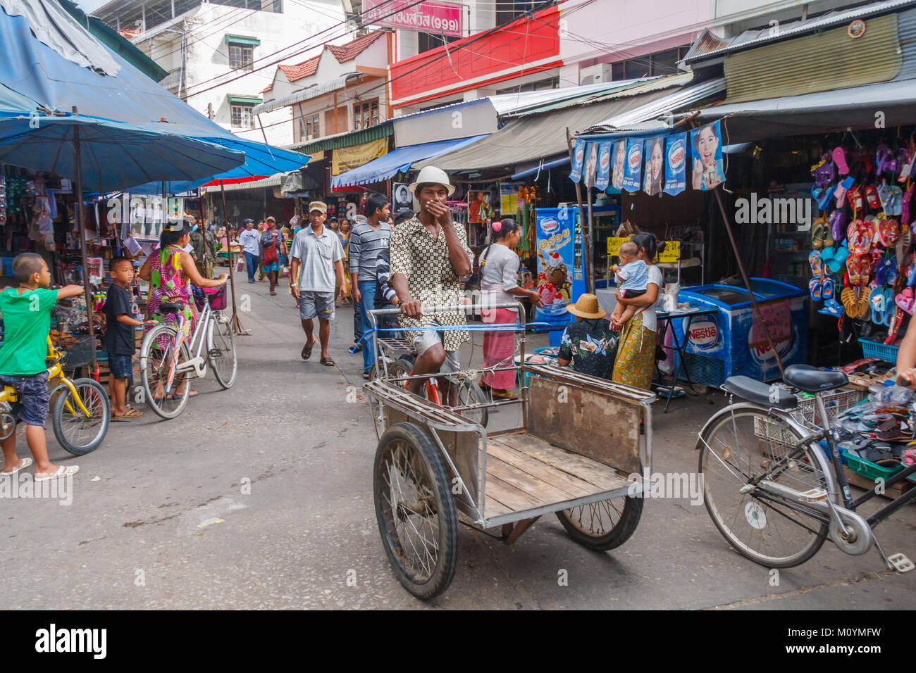 Man riding cart down street, Mae Sot, Thailand Stock Photo