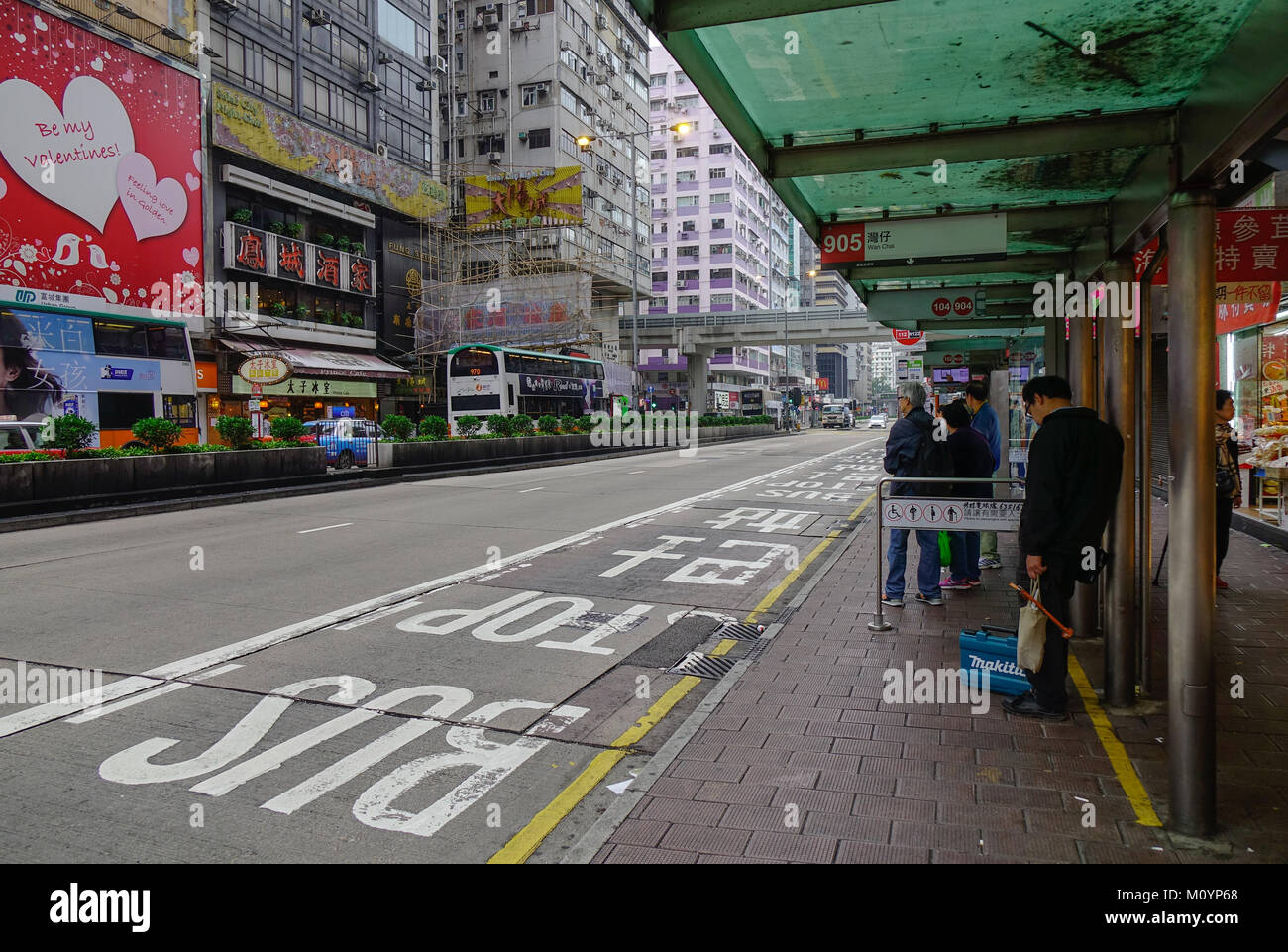 Hong Kong - Mar 29, 2017. People waiting at a bus stand in Hong Kong. Hong Kong has had the highest degree of economic freedom in the world. Stock Photo