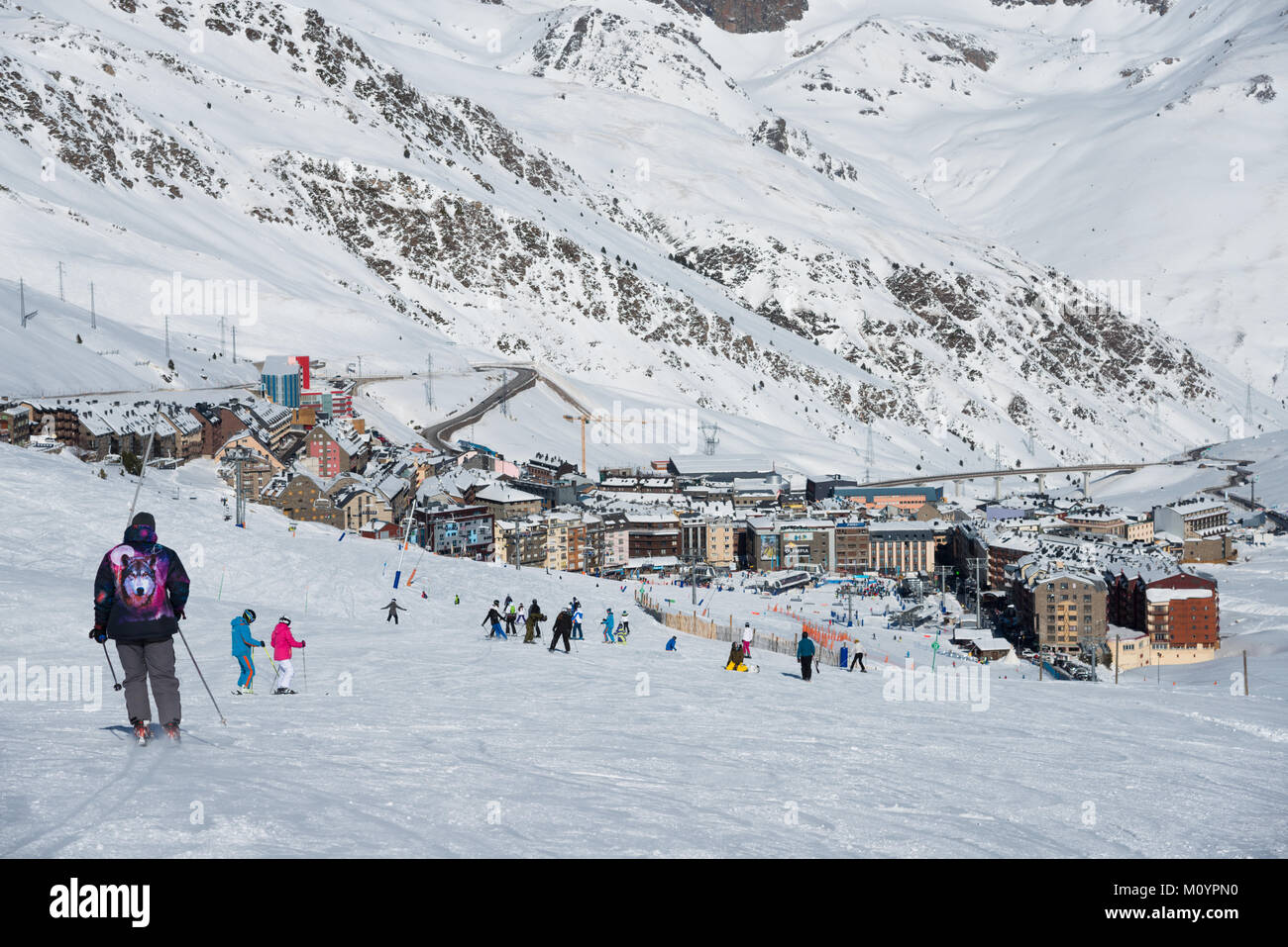 Skiers and snowboarders with Pas de la Casa in the distance