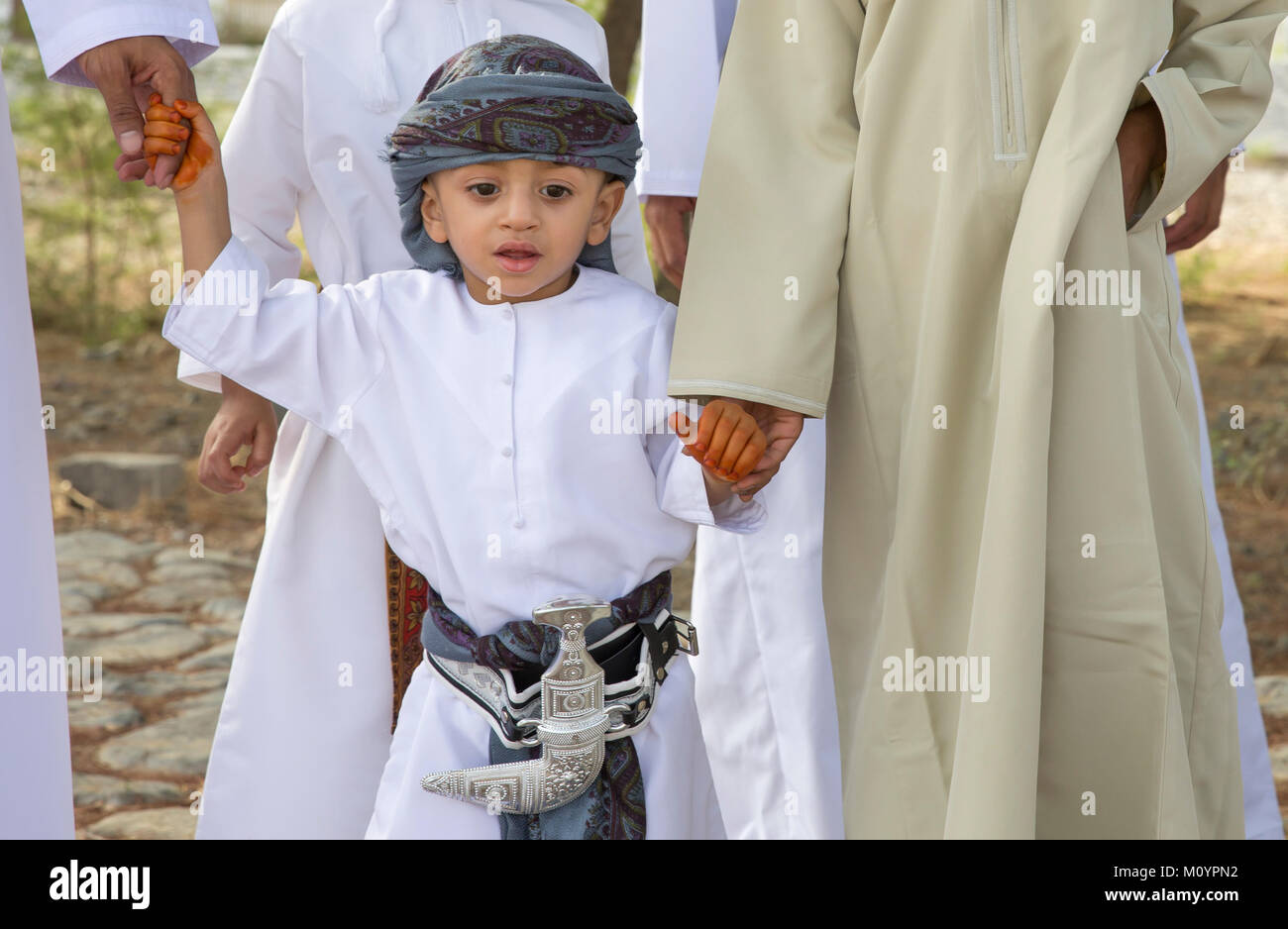Nizwa, Oman - June 26th 2017: omani kid dressed for Eid al Fitr day, that is celebrated at the end of Holy month of Ramadan Stock Photo
