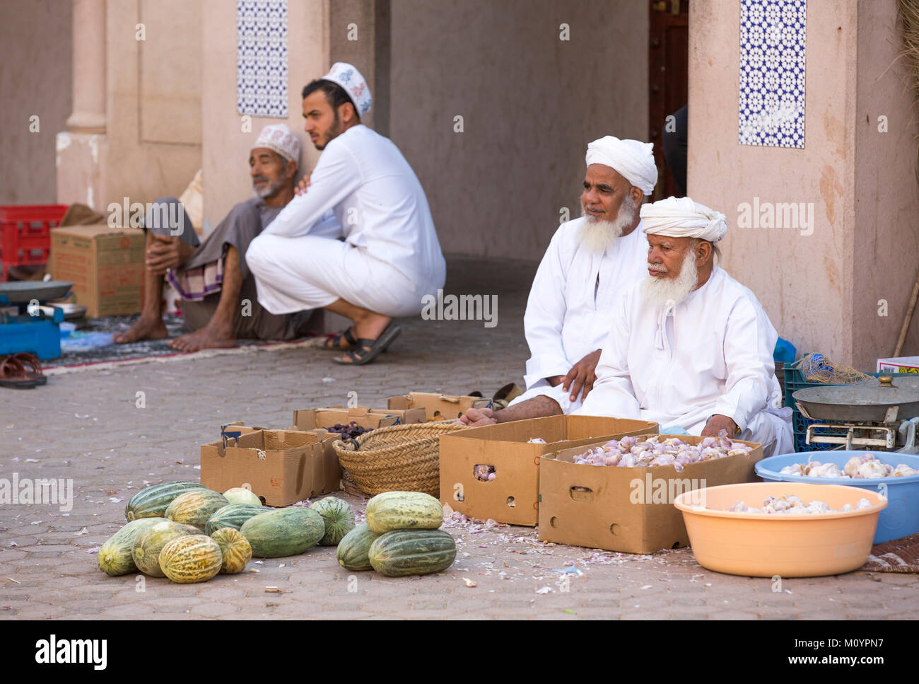 Nizwa, Oman - June 24th, 2017: omani men selling their produce at a streetmarket in old town Stock Photo
