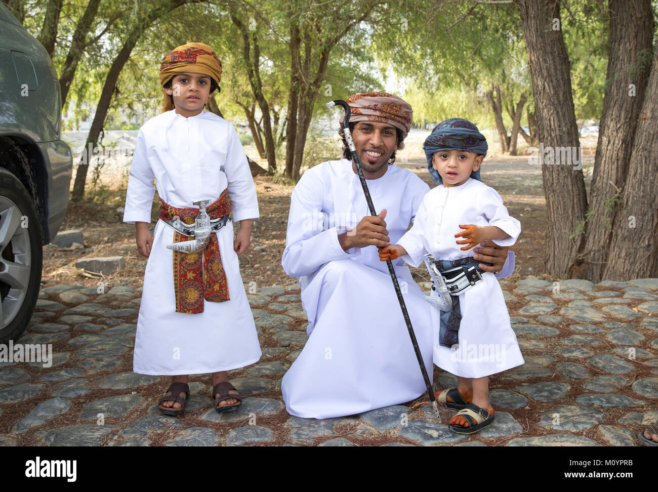 Nizwa, Oman - June 26th 2017: omani family dressed for Eid al Fitr day, that is celebrated at the end of Holy month of Ramadan Stock Photo