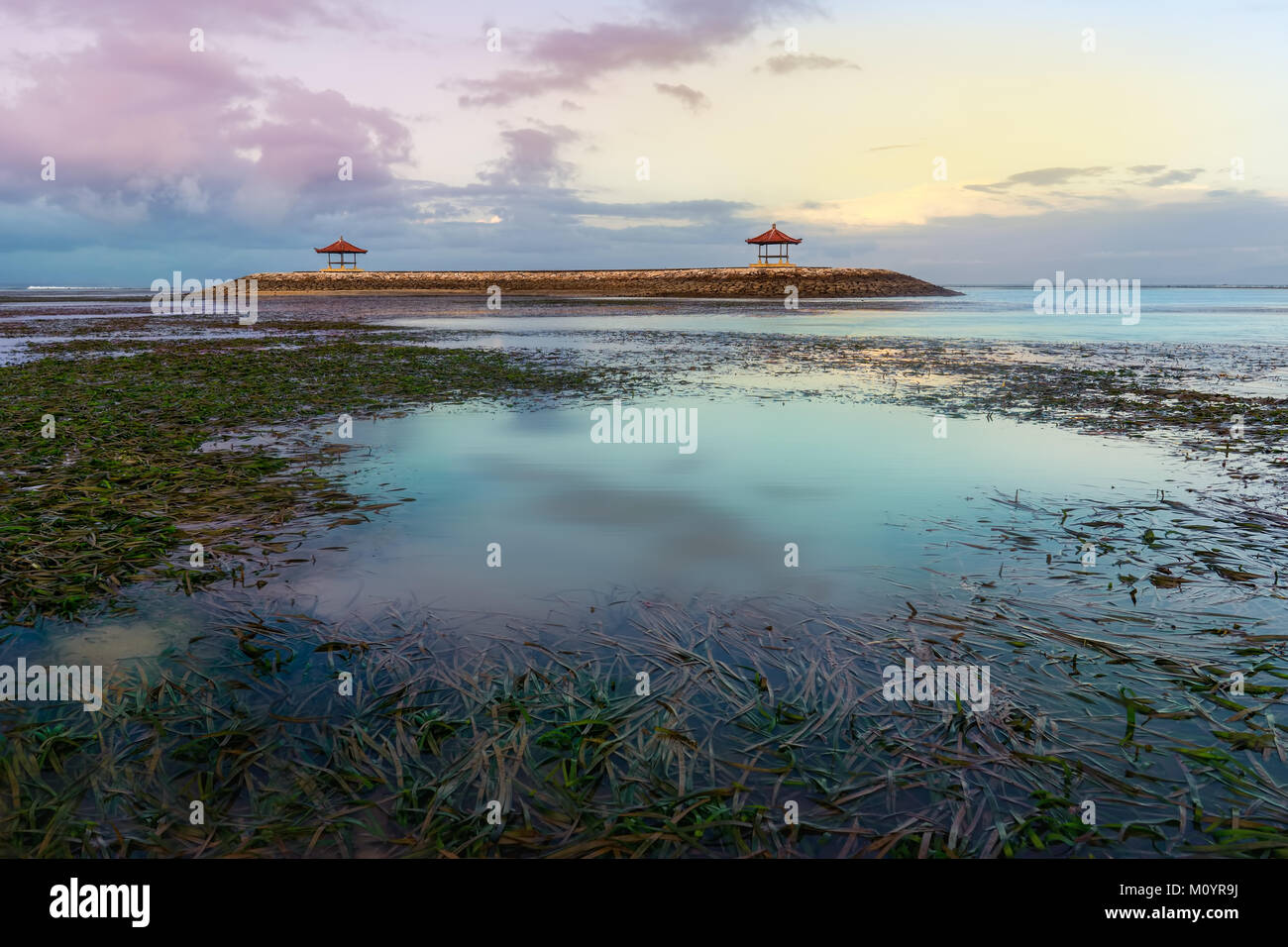 Gazebo in the middle on sea in low tide during sunset or sunrise Stock Photo