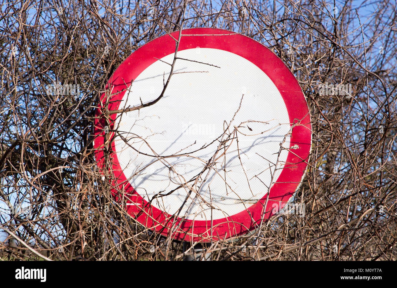 Red circle 30 mph sign with writing bleached and invisible, UK Stock Photo