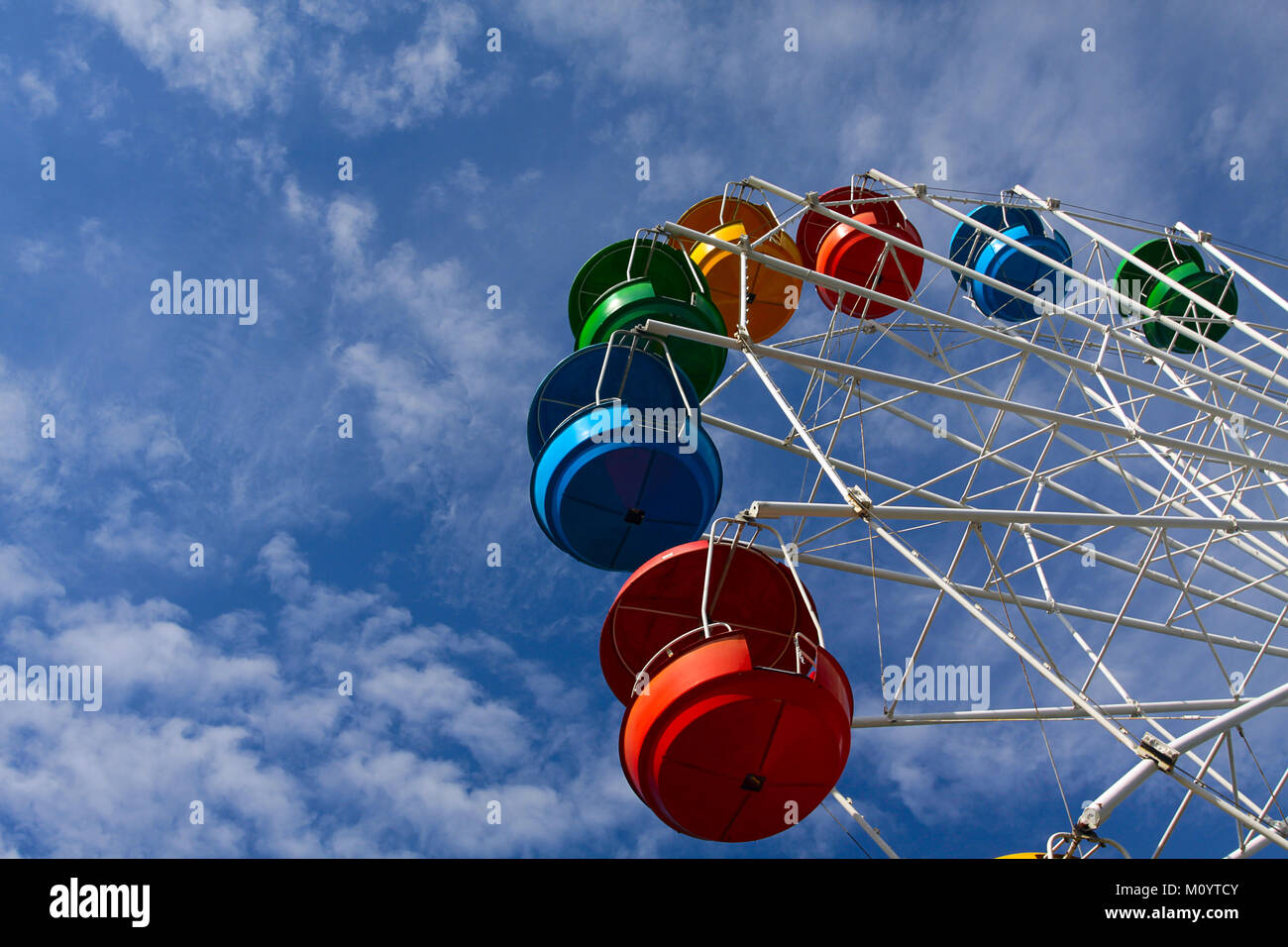 Ferris wheel against blue sky with white clouds Stock Photo - Alamy