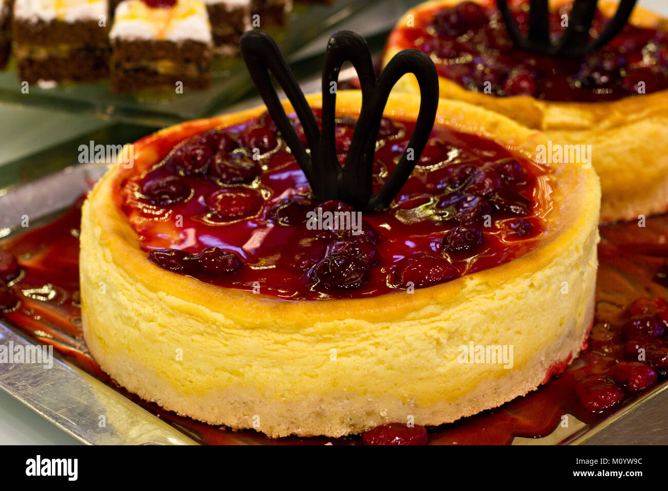 Whole cherry cheesecake with the burgundy jelly and black chocolate