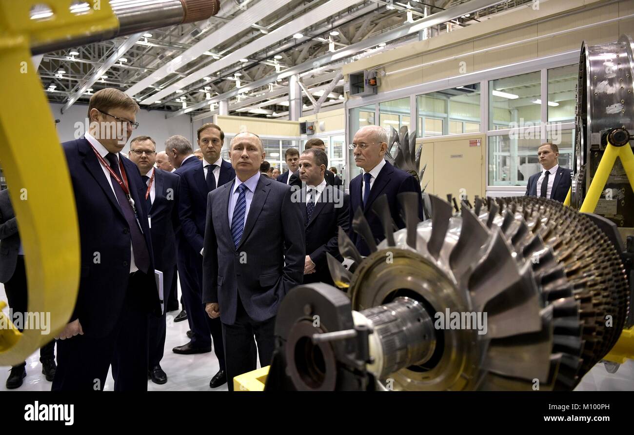 Russian President Vladimir Putin, center, views advanced turbojet helicopter engines during a tour of the Ufa Engine Industrial Association center January 24, 2018 in Ufa, Russia. Stock Photo