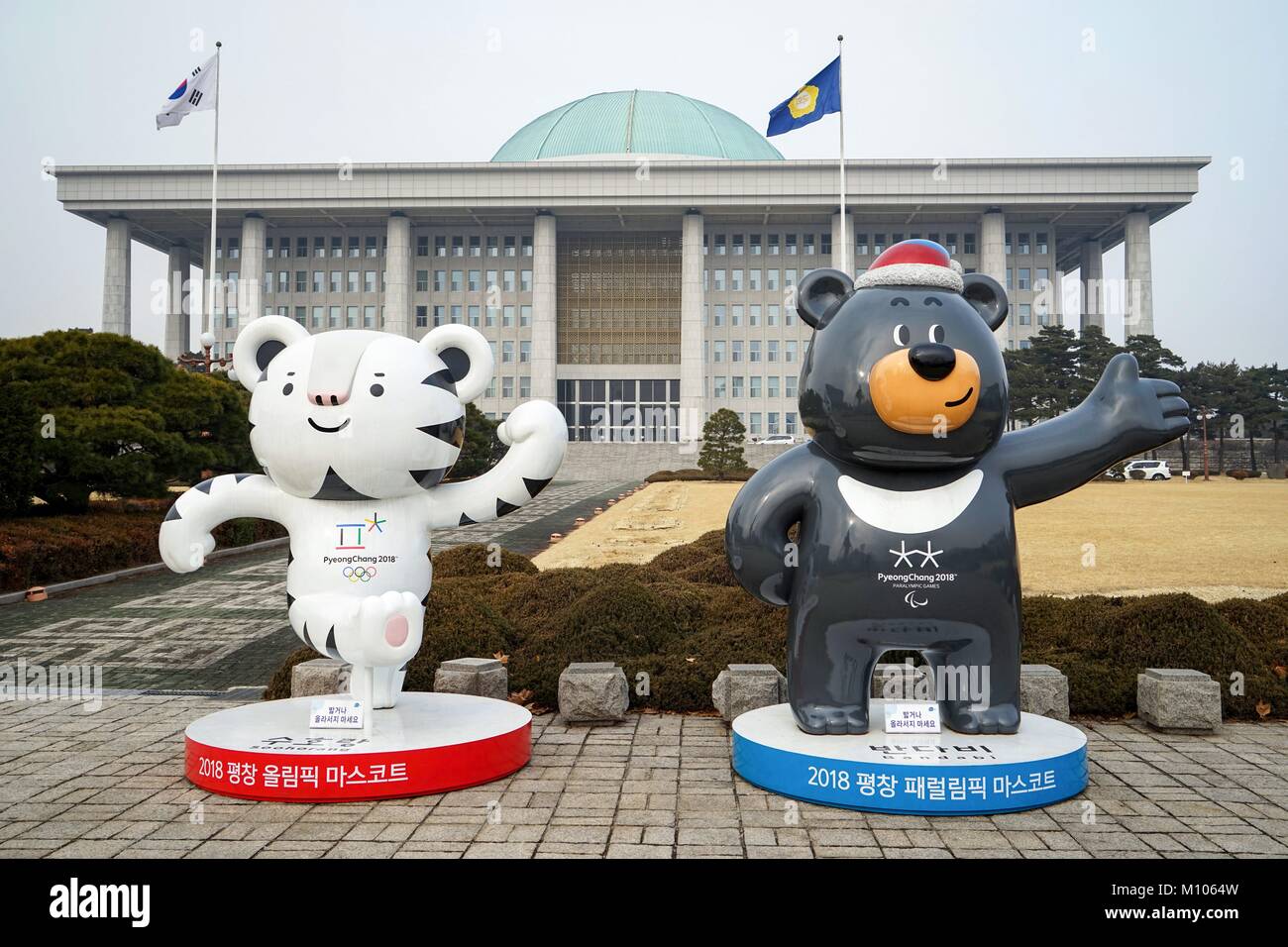 South Korea: The mascots of the PyeongChang 2018 Olympic (Soohorang, left) and Paralympic Winter Games (Bandabi, right) in front of the National Assembly Building of South Korea in Seoul. Photo from 30. December 2017. | usage worldwide Stock Photo