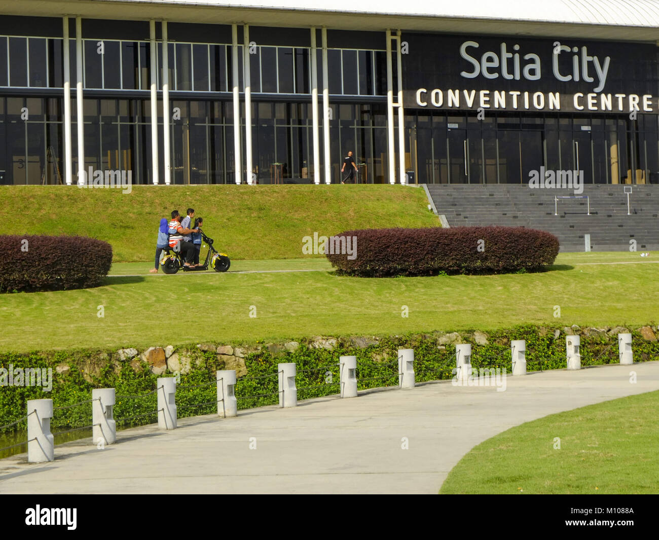 January 22, 2018 - Kuala Lumpur, Kuala Lumpur, Malaysia - A father take his children for a rides on a mini scooter at Setia City convention centre...Kuala Lumpur or commonly known as KL is the national capital for Malaysia and is the fastest growing metropolitan regions in South-East Asia. The urban city is also well known to the world for tourism and shopping. Kuala Lumpur has a great public transportation for people travel around the city. (Credit Image: © Faris Hadziq/SOPA via ZUMA Wire) Stock Photo