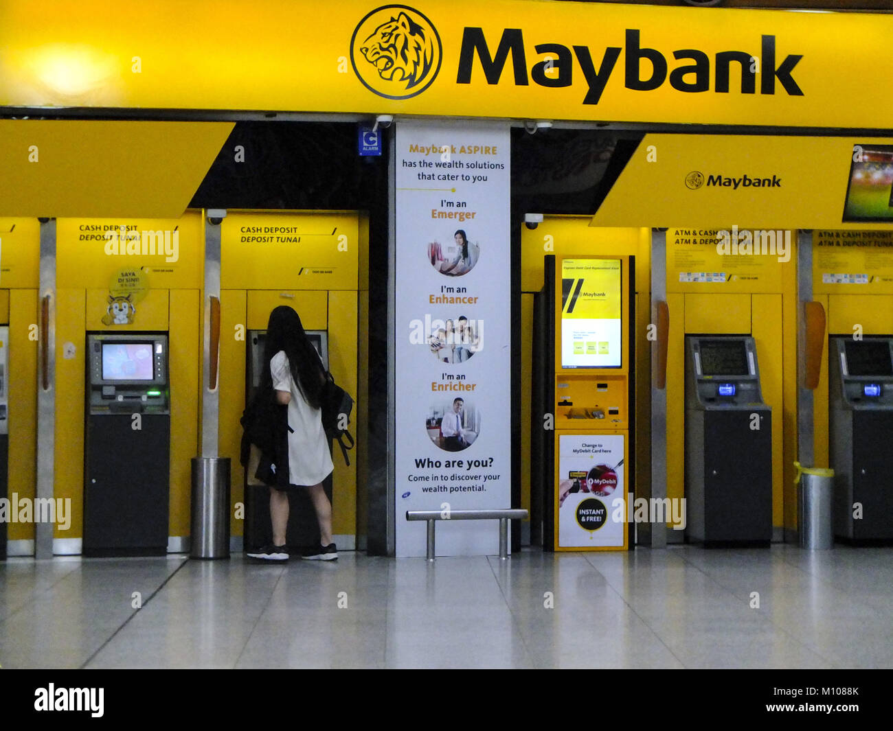 January 24, 2018 - Kuala Lumpur, Kuala Lumpur, Malaysia - A women is seen using Maybank Atm machine at Kuala Lumpur...Kuala Lumpur or commonly known as KL is the national capital for Malaysia and is the fastest growing metropolitan regions in South-East Asia. The urban city is also well known to the world for tourism and shopping. Kuala Lumpur has a great public transportation for people travel around the city. (Credit Image: © Faris Hadziq/SOPA via ZUMA Wire) Stock Photo