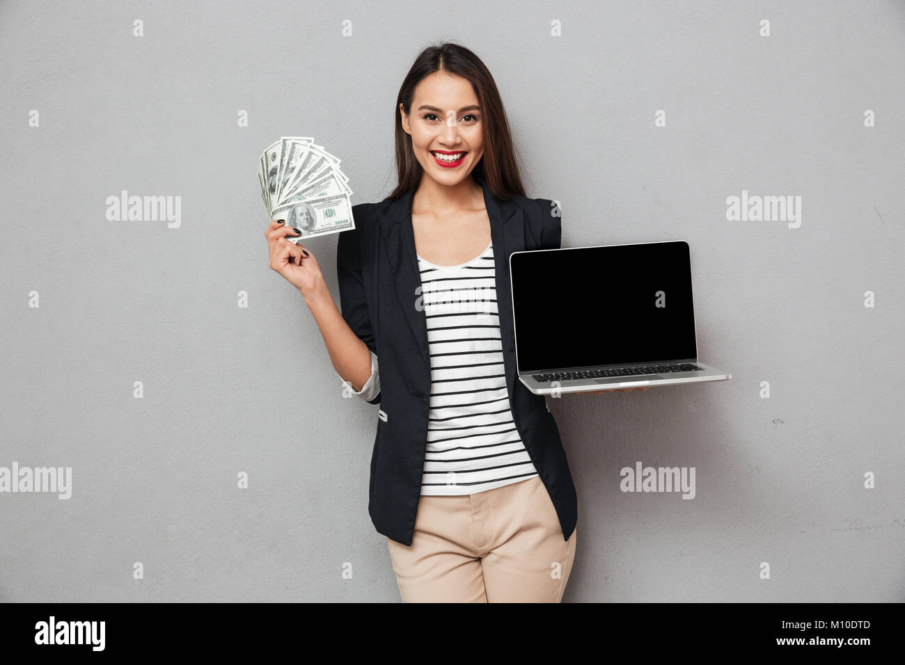 Happy asian business woman showing blank laptop computer and holding ...