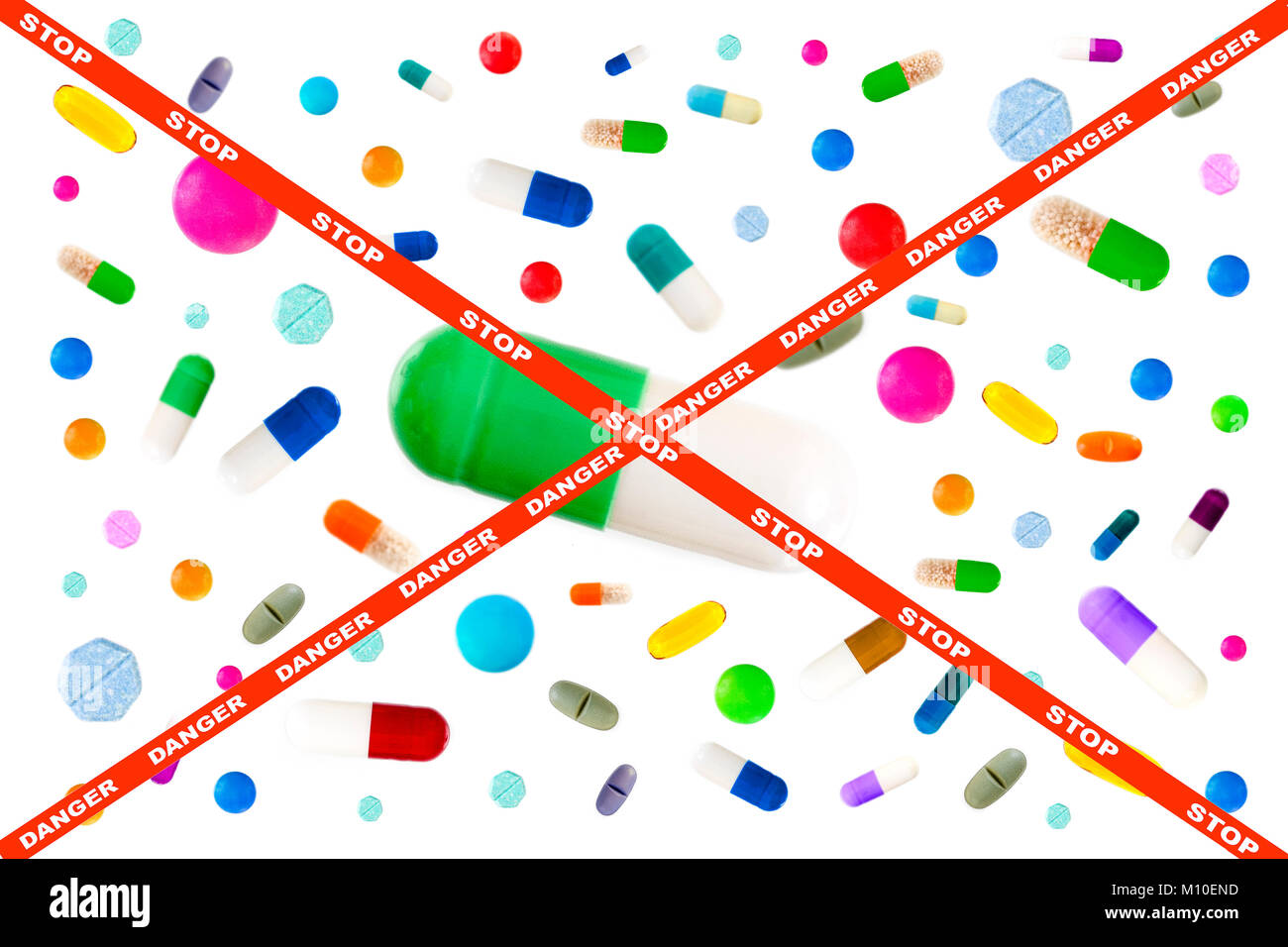 picture crossing through stop and danger on red ribbon, Symbol image of drugs danger : Many colorful medicines. Pills and capsules on white background Stock Photo
