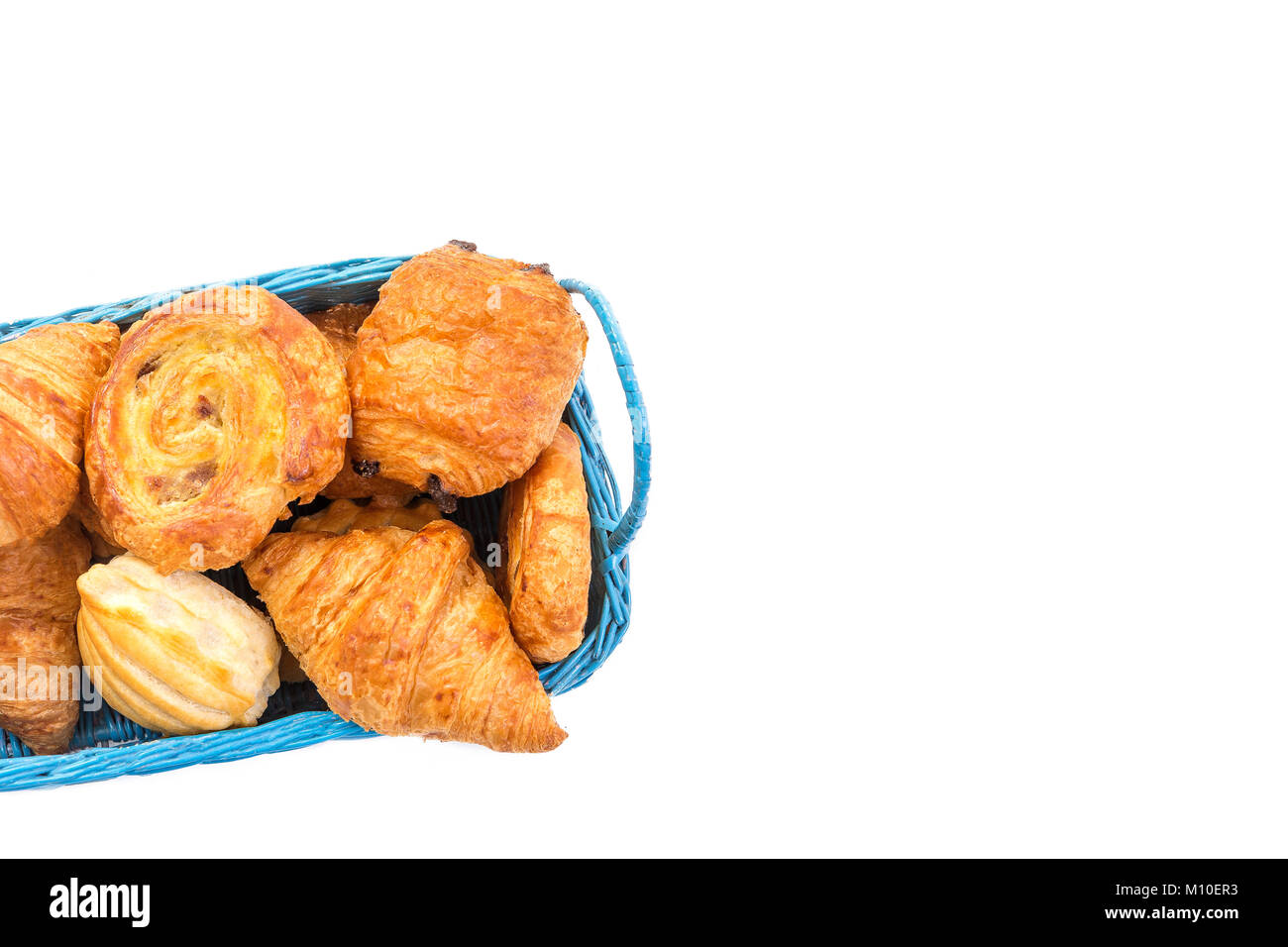 blue basket of assortment of pastries breakfast food on white copy space Stock Photo