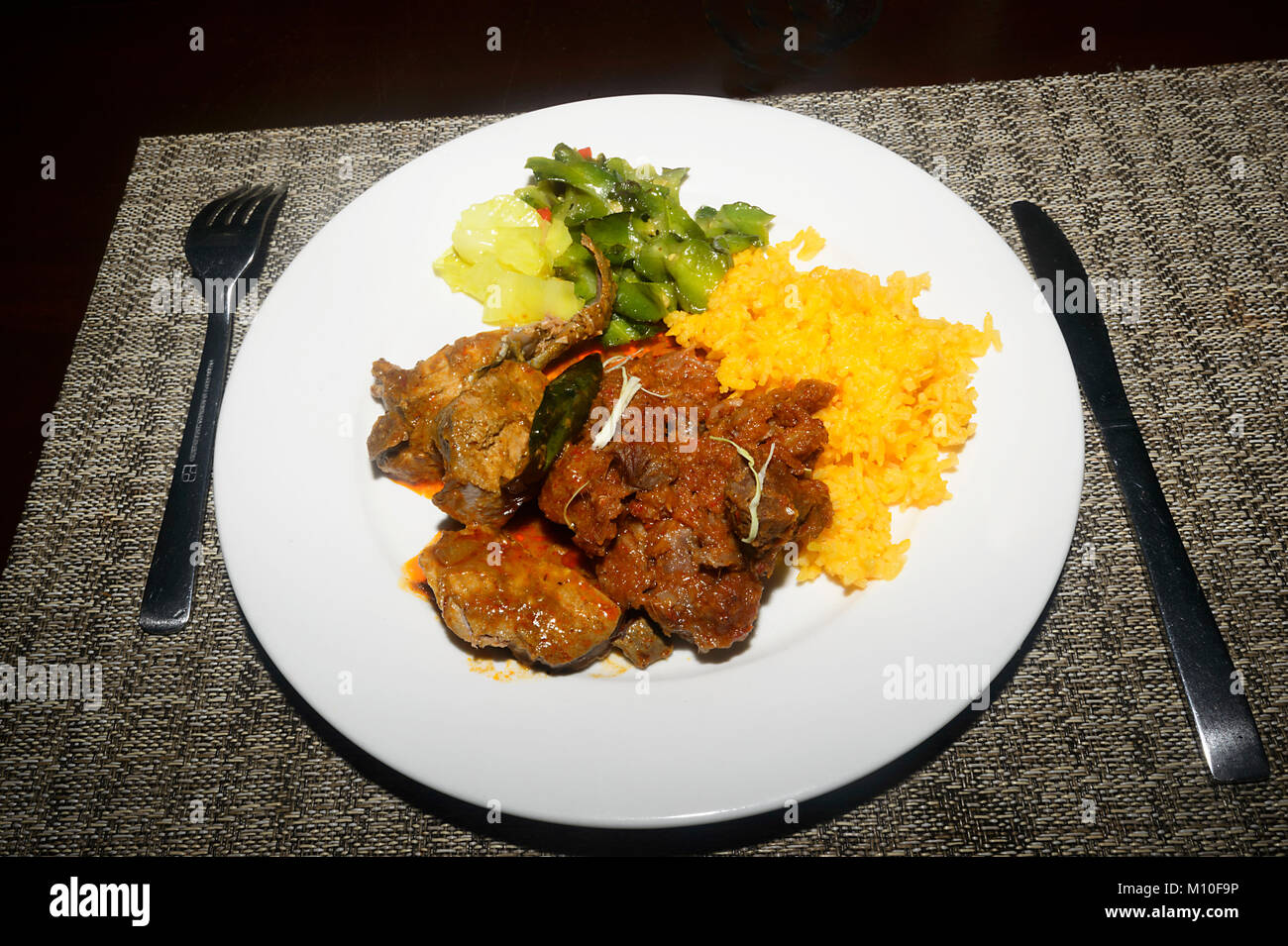 A Malaysian dish of Beef Asam Pedas with rice and fresh vegetables served at Tabin Wildlife Resort, Sabah, Borneo, Malaysia Stock Photo