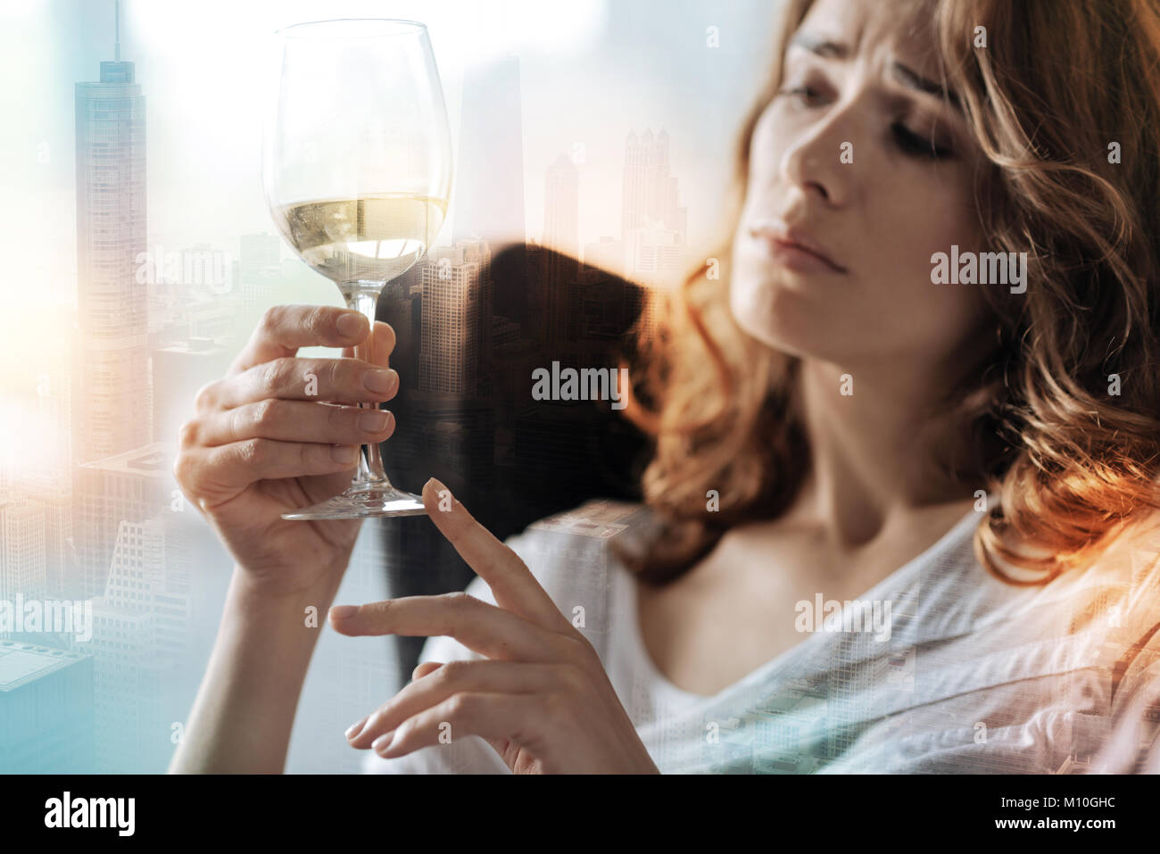 Upset woman holding a wineglass Stock Photo
