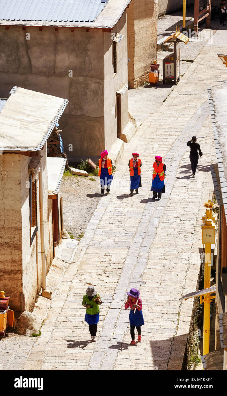 Shangri-La, China - September 25, 2017: Women walk the road in Songzanlin Monastery. Stock Photo