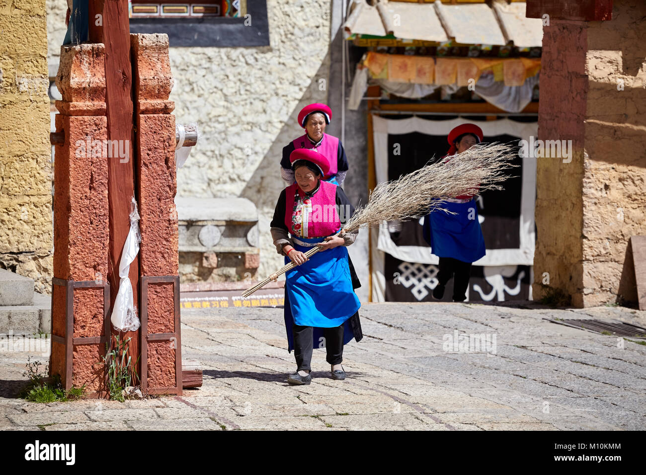 Shangri-La, China - September 25, 2017: Women clean up the Songzanlin Monastery, built in 1679, is the largest Tibetan Buddhist monastery in Yunnan pr Stock Photo