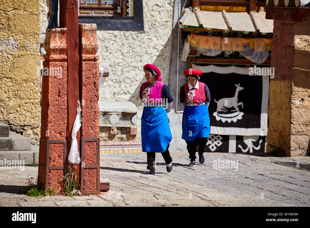 Shangri-La, China - September 25, 2017: Women walk in the Songzanlin Monastery, built in 1679, is the largest Tibetan Buddhist monastery in Yunnan pro Stock Photo