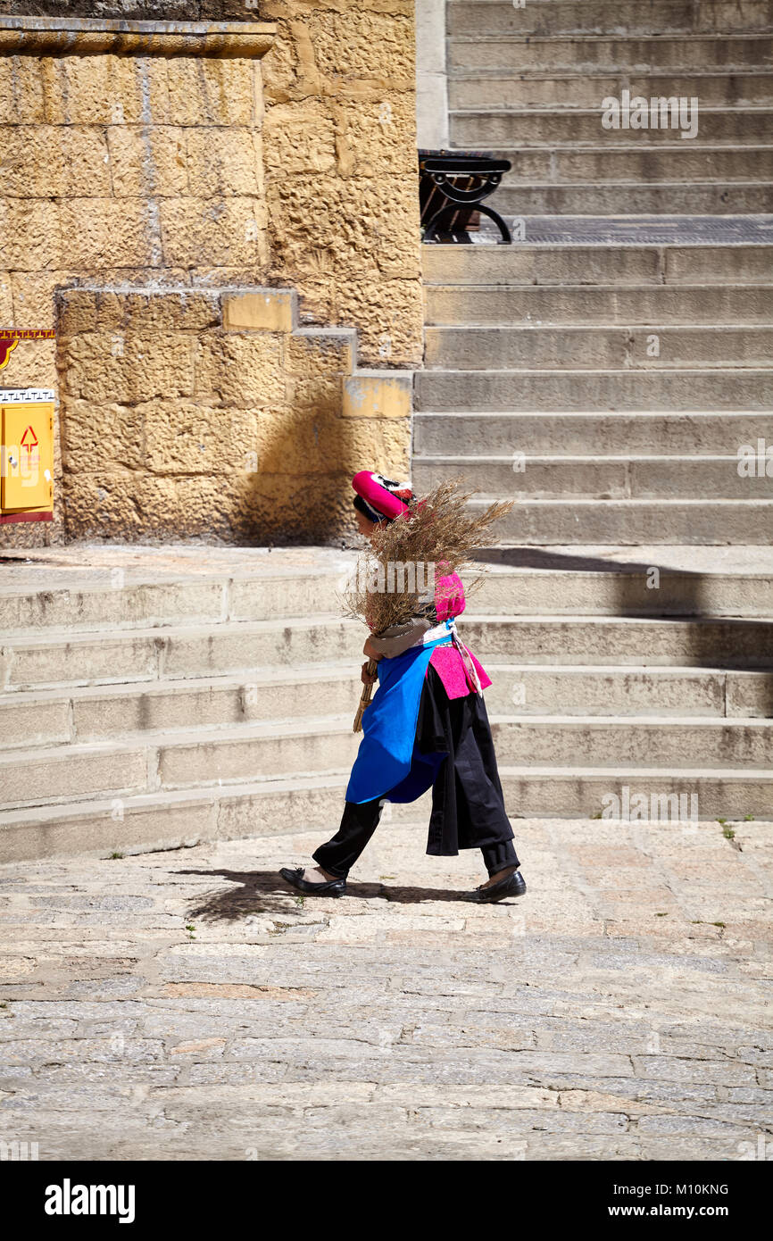 Shangri-La, China - September 25, 2017: Women with a broom in the Songzanlin Monastery, built in 1679. Stock Photo