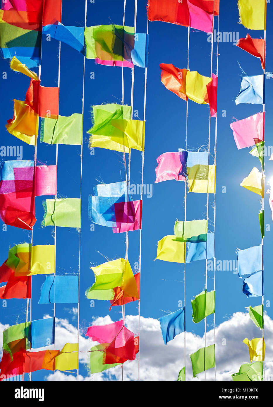 Colorful prayer flags against the blue sky. Stock Photo