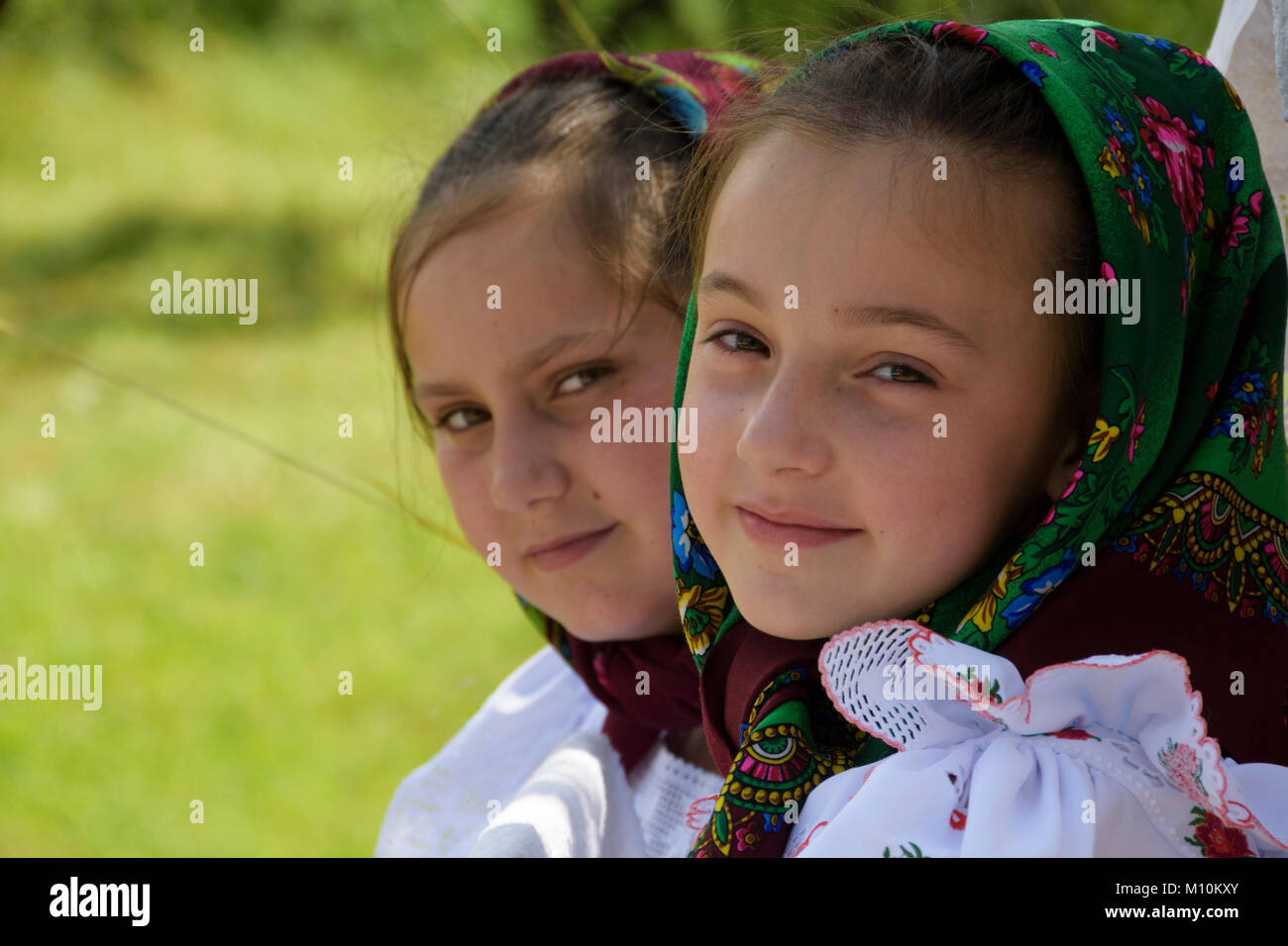 Romania, Maramures County, Village of Breb.Procession in honour of St. Paul, end of june. Two young girls with headscarf Stock Photo