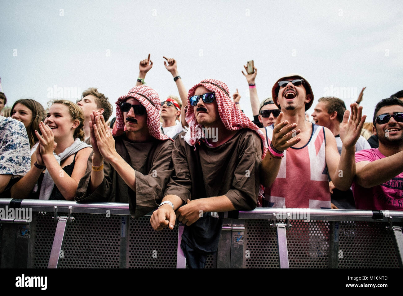 Two festival guests and music fans wear costumes to praise their idol