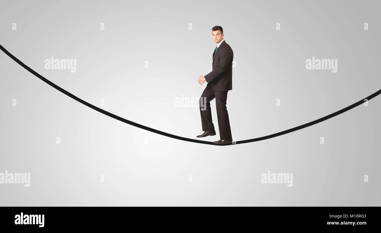 Businessman walking a tightrope hi-res stock photography and