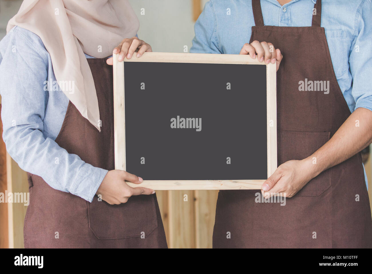portrait of two young business partner open their coffee shop. standing