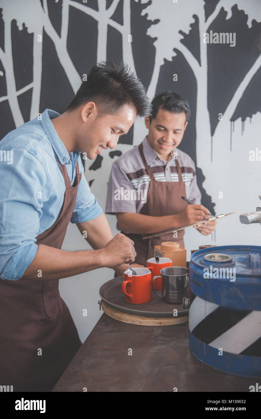 portrait of two male waiter preparing menu for customer Stock Photo - Alamy