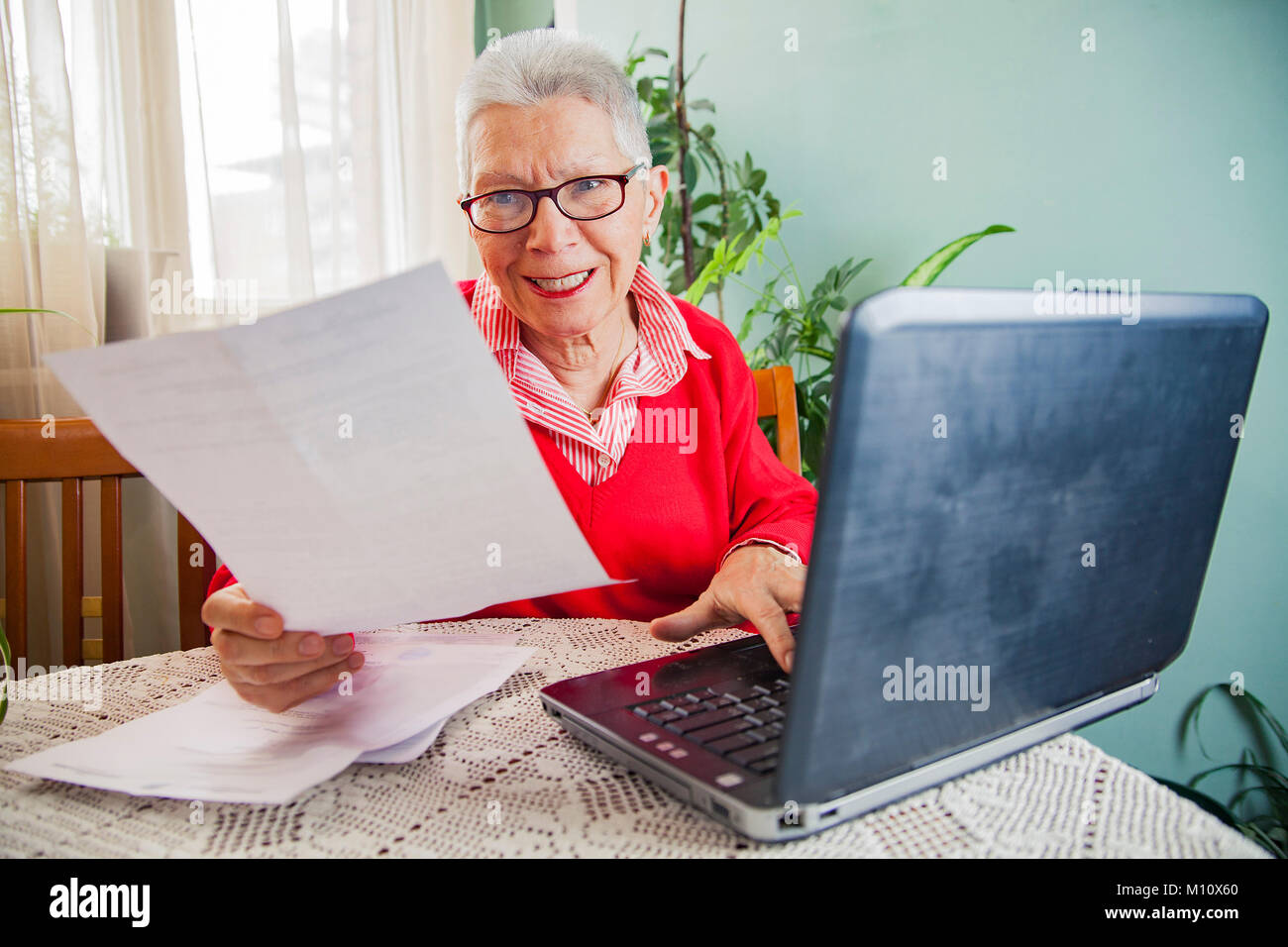 Senior woman outraged with bills from electricity company Stock Photo