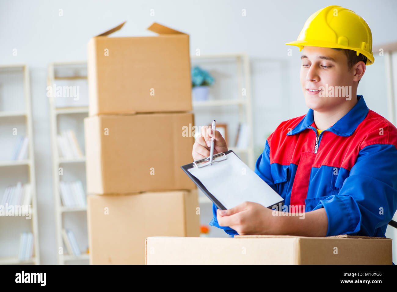 Young man working in relocation services with boxes Stock Photo - Alamy