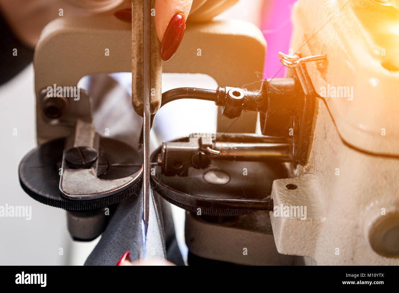 A close-up of a mettalic furrier sewing machine for fur and leather ...