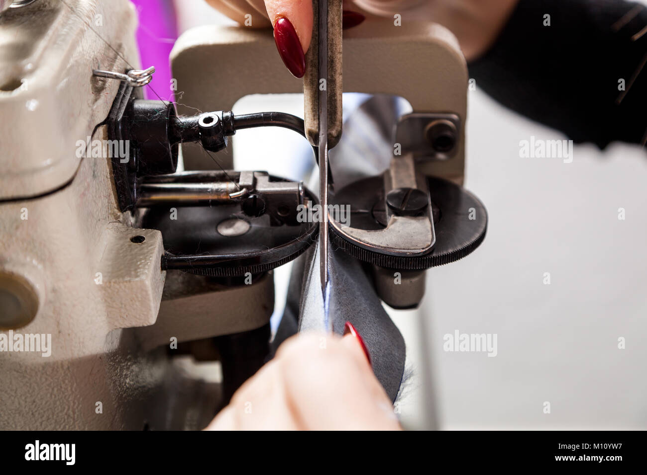 A close-up of a mettalic furrier sewing machine for fur and leather ...