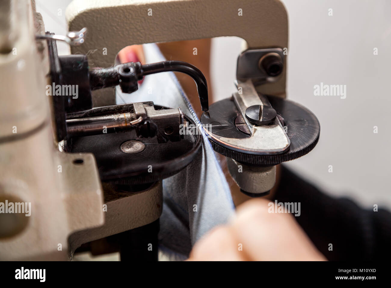 A close-up of a mettalic furrier sewing machine for fur and leather ...