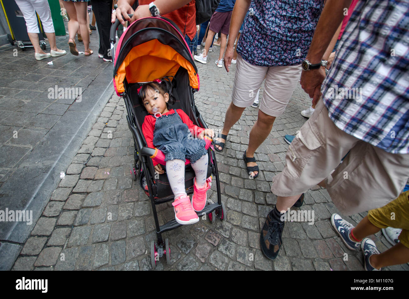 Brussels, Belgium. Young girl in a pushchair / buggy [no model release] Stock Photo