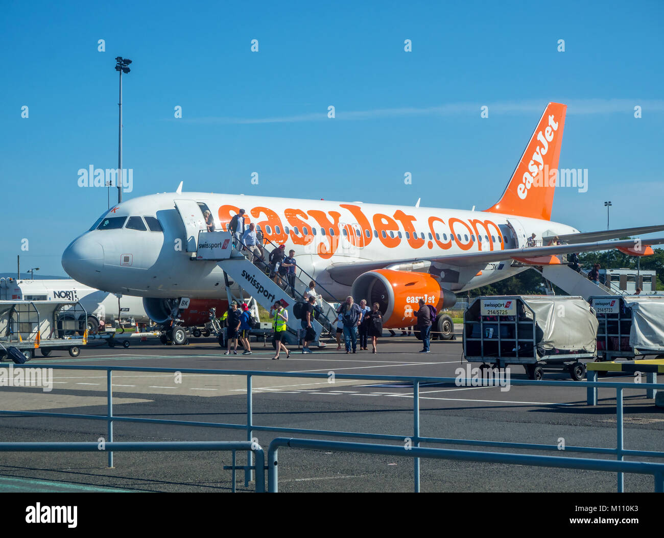 Belfast, Norther Ireland, UK - July 18, 2017: Passengers leaving the EasyJet airliner Airbus a320 on Belfast International Airport. Stock Photo