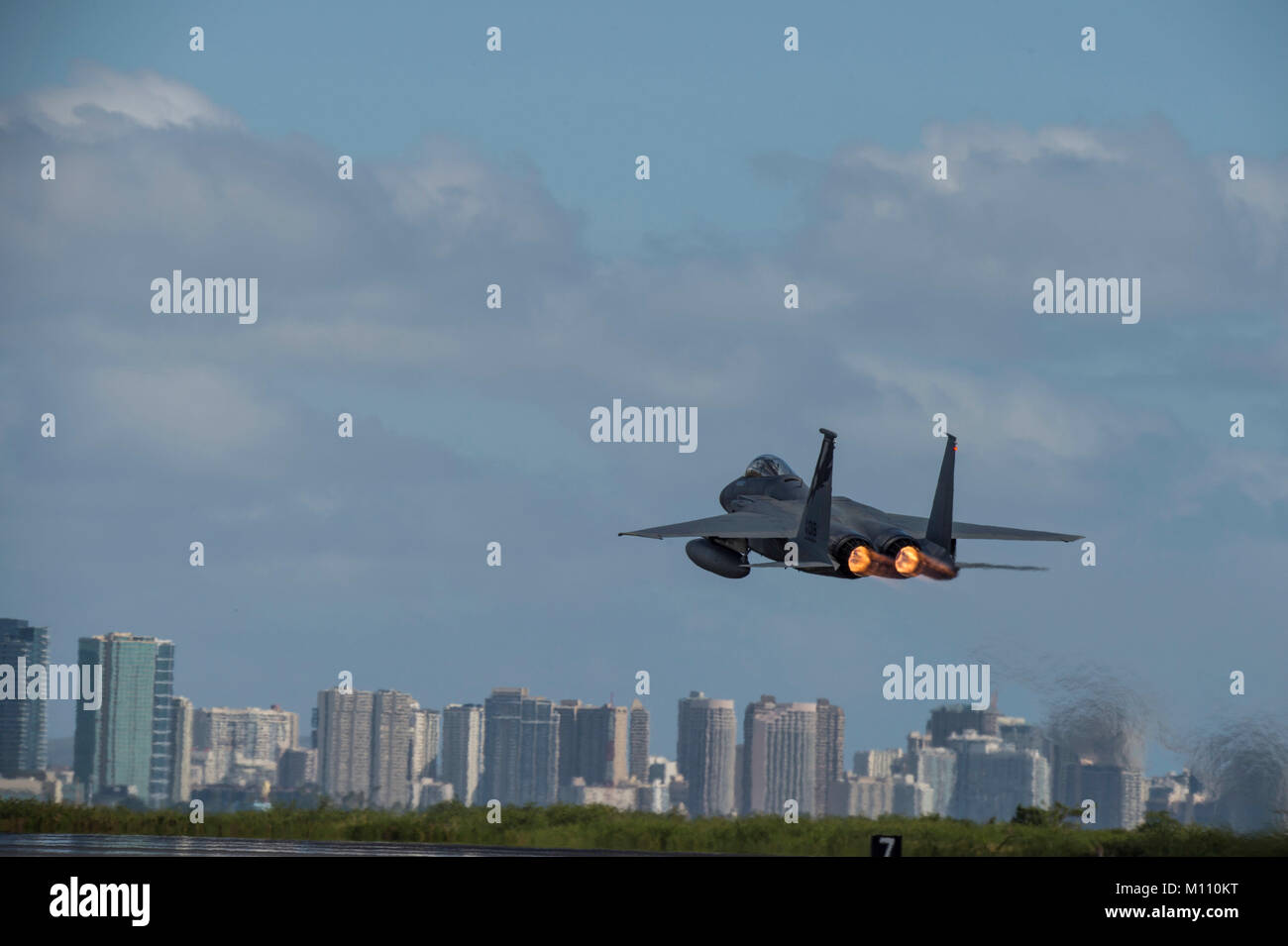 U.S. Air Force F-15 Eagle from California Air National Guard’s 144th Fighter Wing takes flight over the city of Honolulu during Sentry Aloha 18-01 Jan. 22, 2018 at Joint Base Pearl Harbor-Hickam, Hawaii. Sentry Aloha provides the Air National Guard, U.S. Air Force and DoD counterparts a multi-faceted, joint venue with supporting infrastructure and personnel that incorporates current, realistic integrated training. (Air National Guard photo by Senior Master Sgt. Chris Drudge) Stock Photo