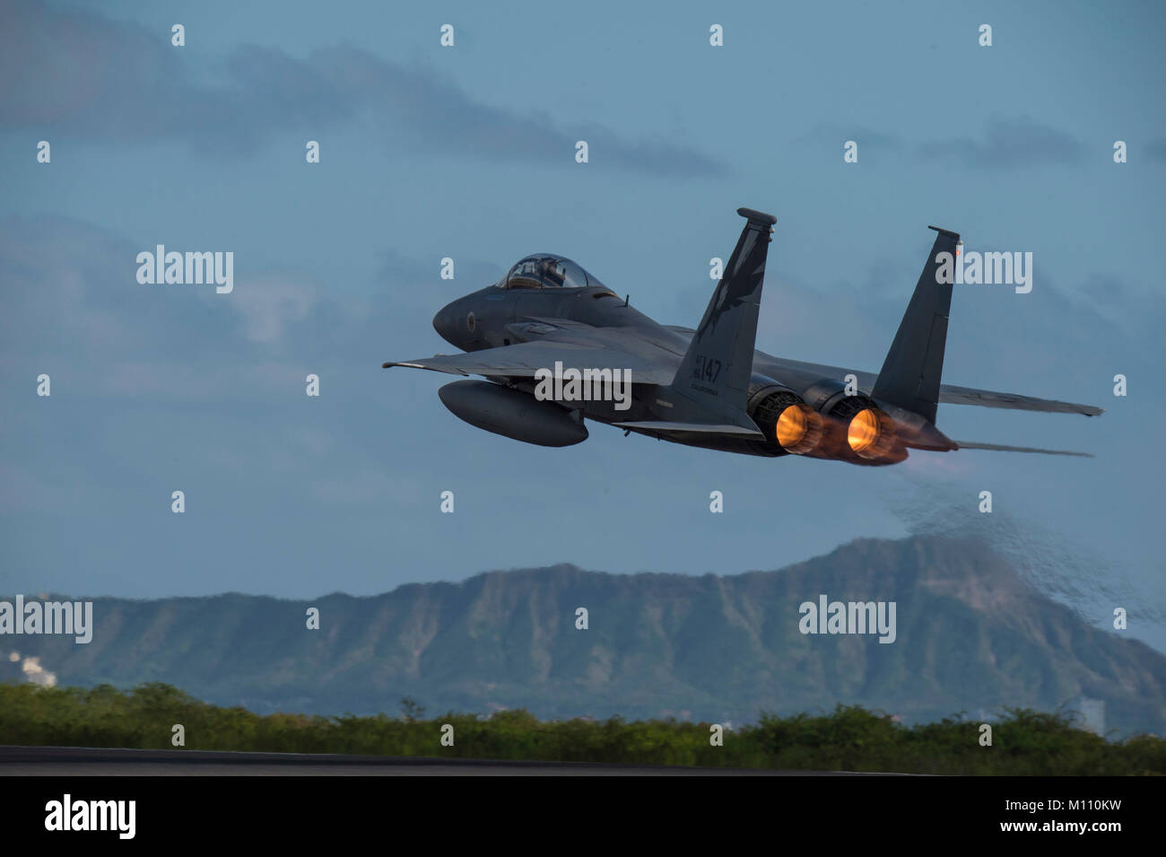 U.S. Air Force F-15 Eagle from California Air National Guard’s 144th Fighter Wing takes flight over Diamond Head during Sentry Aloha 18-01 Jan. 22, 2018 at Joint Base Pearl Harbor-Hickam, Hawaii. Sentry Aloha provides the Air National Guard, U.S. Air Force and DoD counterparts a multi-faceted, joint venue with supporting infrastructure and personnel that incorporates current, realistic integrated training. (Air National Guard photo by Senior Master Sgt. Chris Drudge) Stock Photo