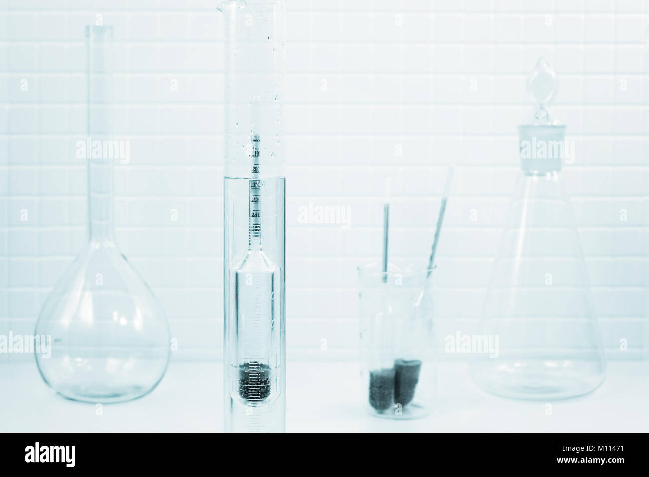 Measurement of  liquid density with a hydrometer in a lab Stock Photo