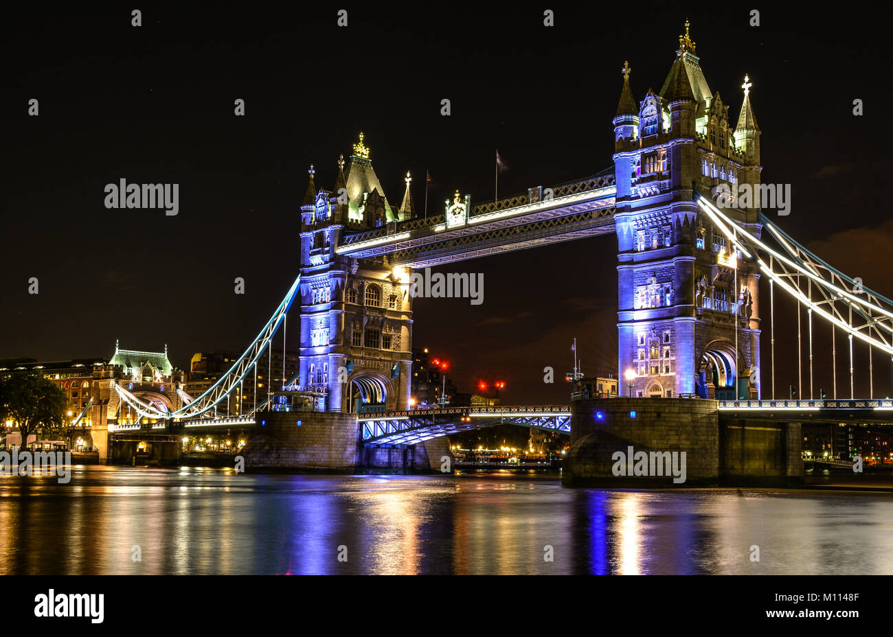 Tower Bridge is a famous icon of London, England that was built in 1894 on river Thames. Each tower reaches a height of 65 meters. Stock Photo