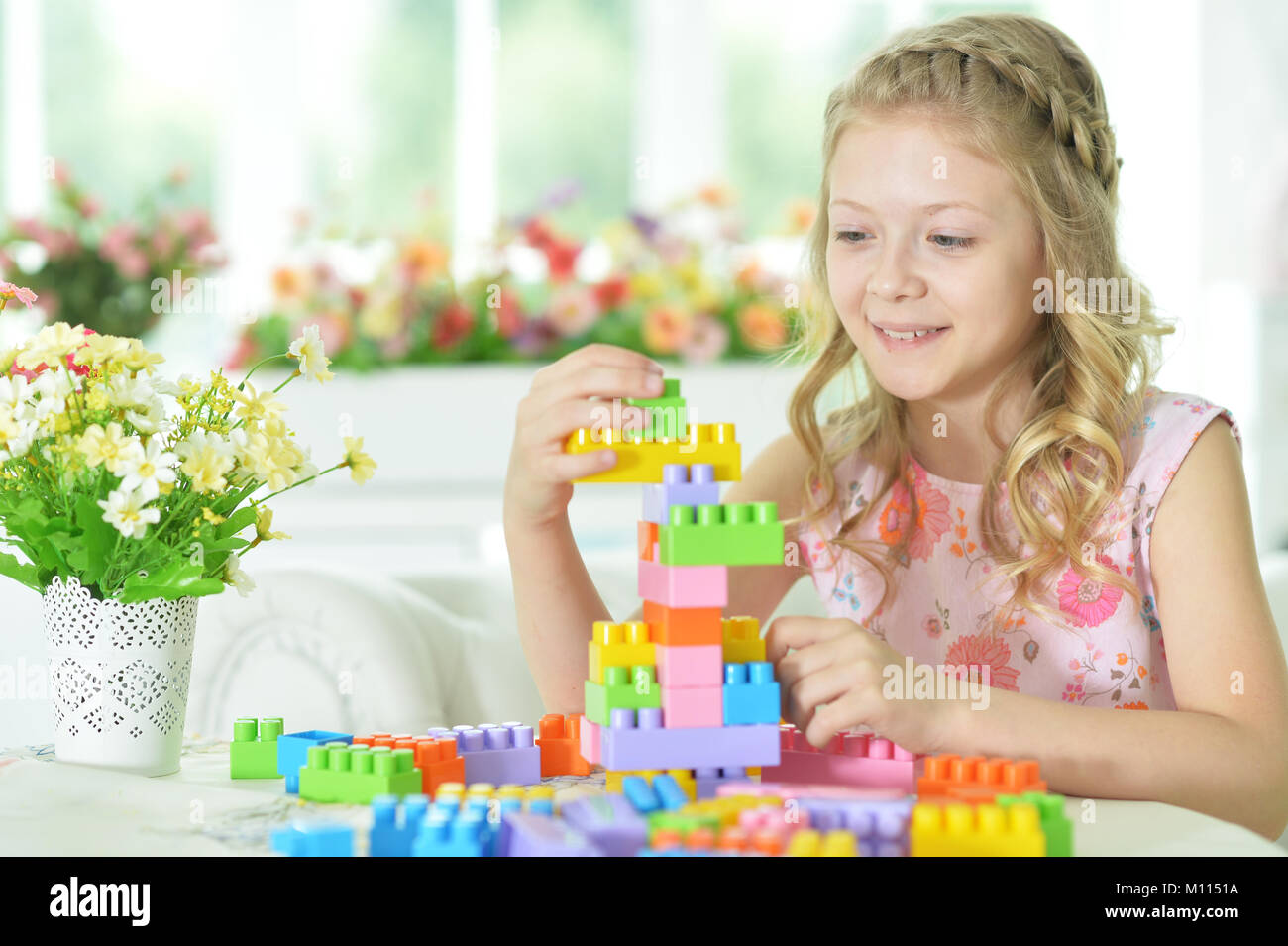 little girl with colorful plastic blocks Stock Photo - Alamy