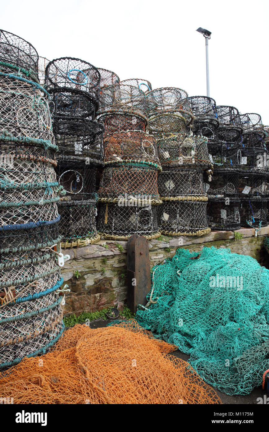 Modern Lobster pots and fishing nets drying on the harbour side. Stock Photo