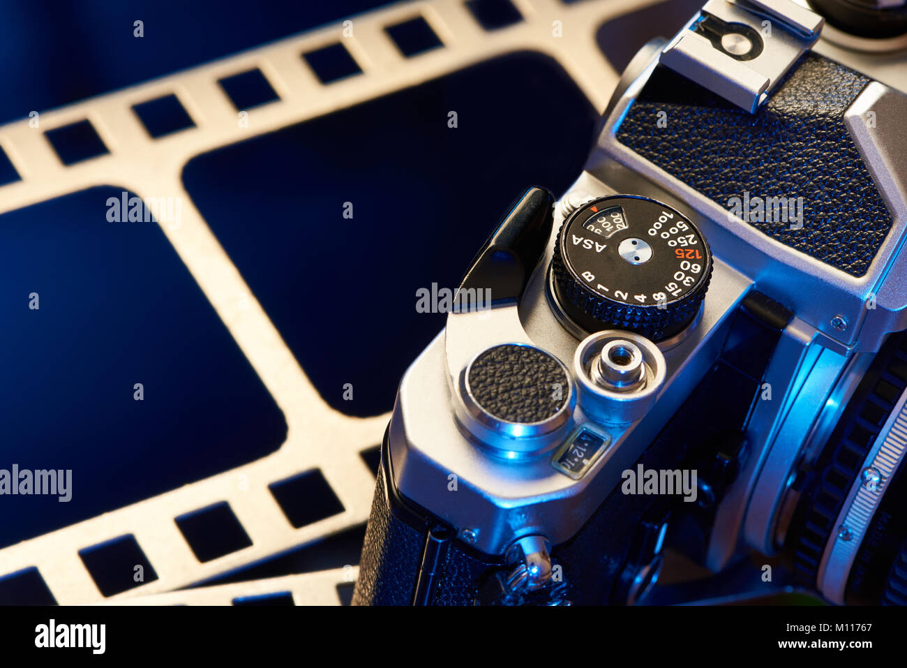 Shutter cocking lever SLR on film perforation background Stock Photo
