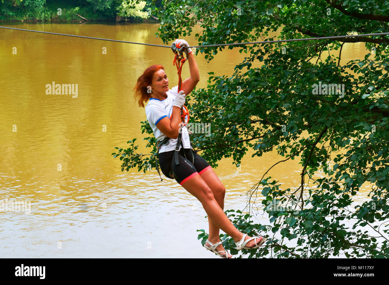 girl in a rope Park, fun on the ropes, flying on ropes across the river