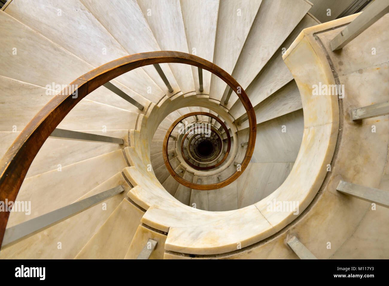 Marble spiral staircase going down Stock Photo