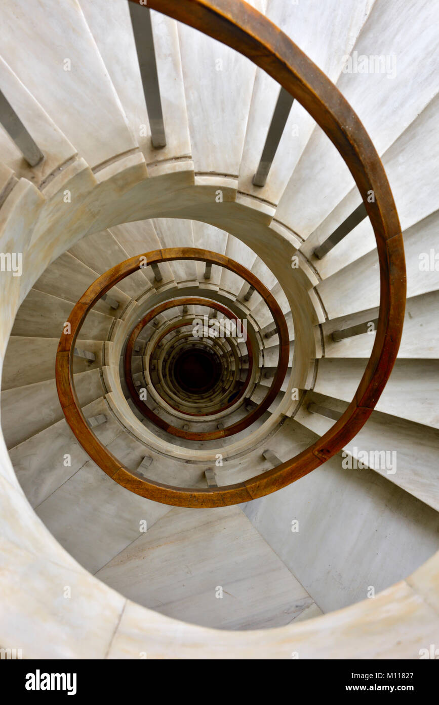 Marble spiral staircase going down Stock Photo