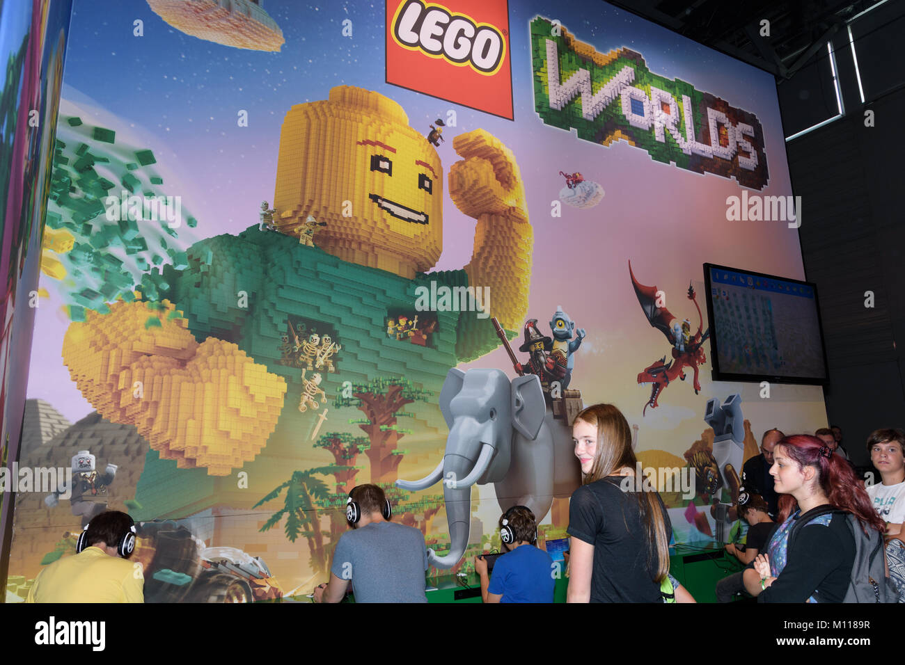 Cologne, Germany - August 24, 2017: Trade fair visitors playing Lego Worlds at the booth of the company Lego at Gamescom 2017. Gamescom is trade fair Stock Photo